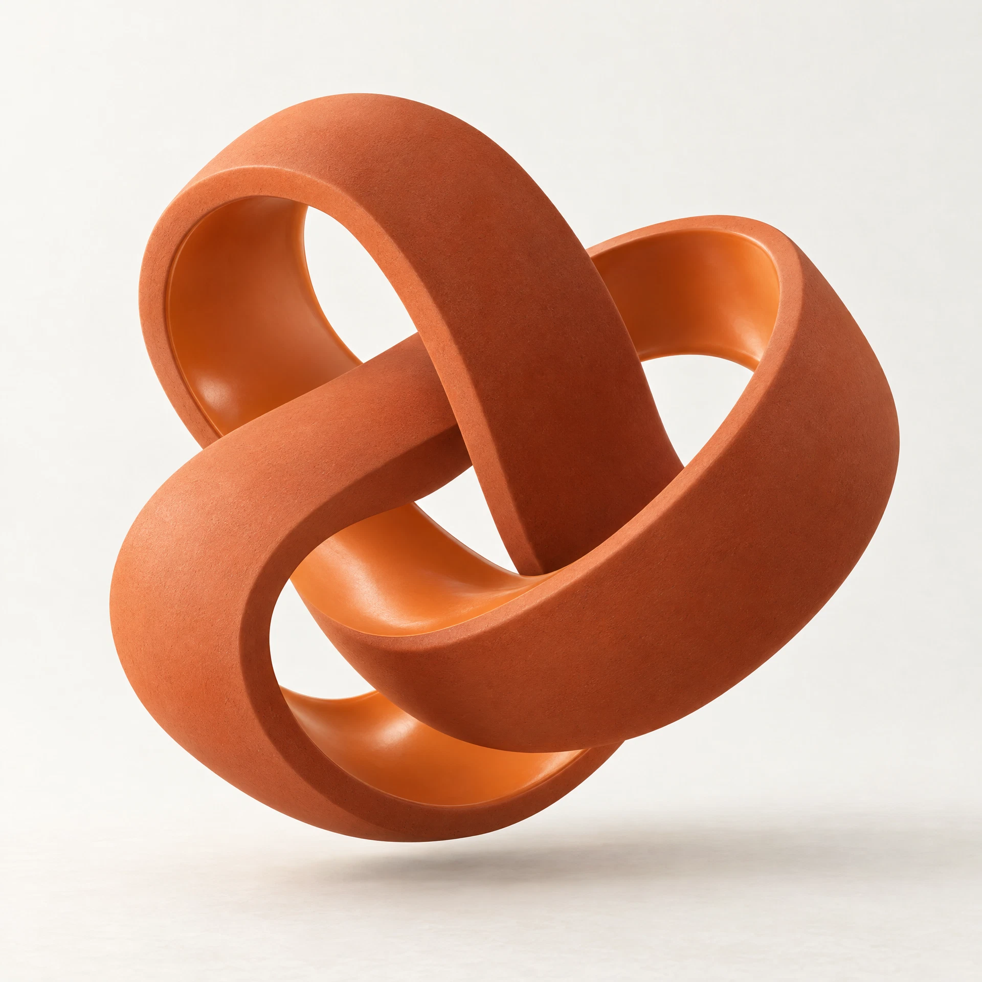 An orange interlocking ribbon sculpture representing craftsmanship and growth
